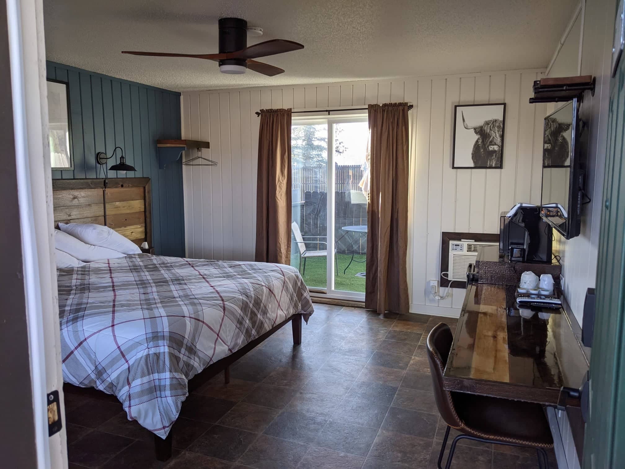 Motel room with king bed and desk