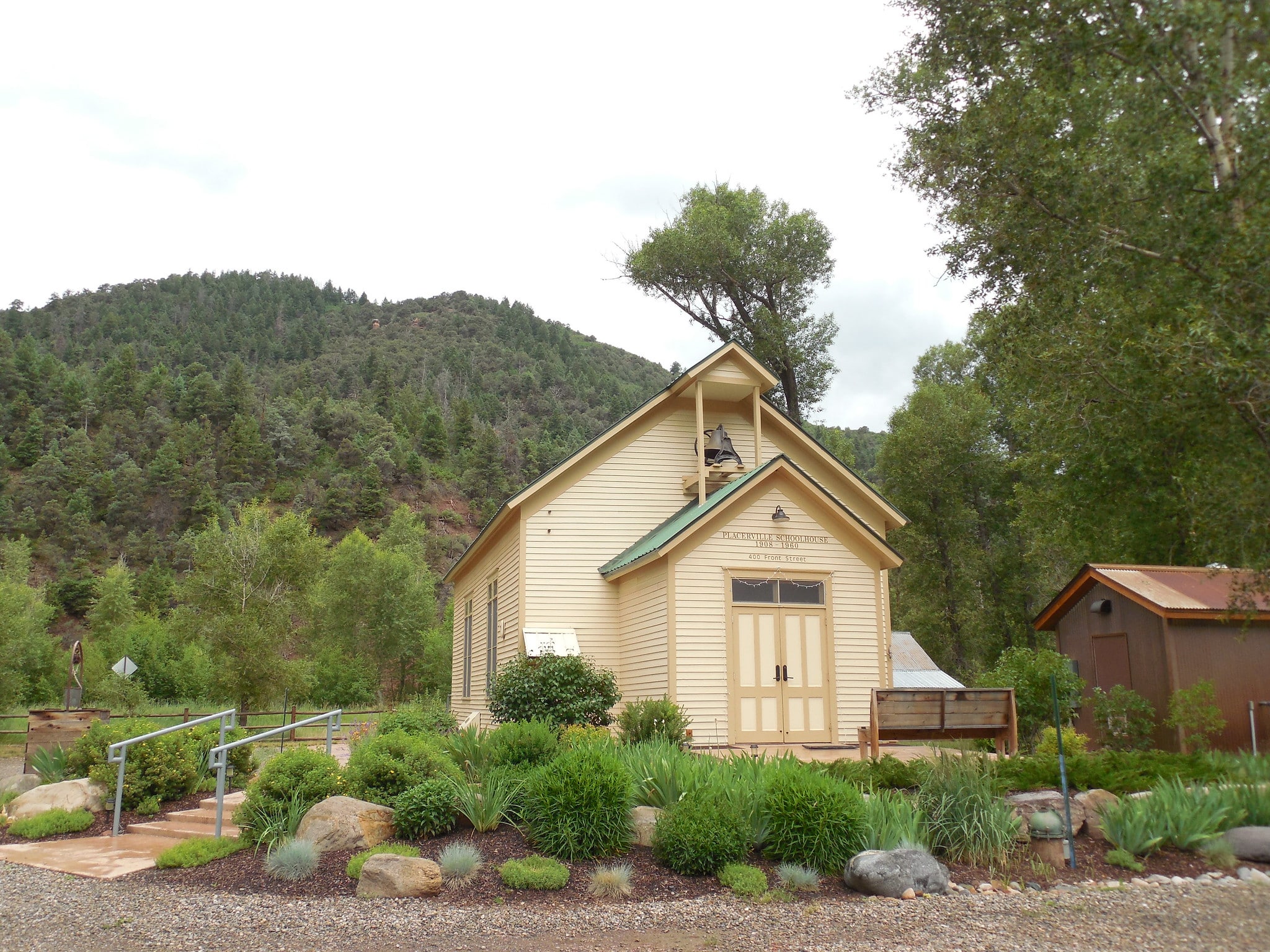 Historic schoolhouse, cream colored with a green roof