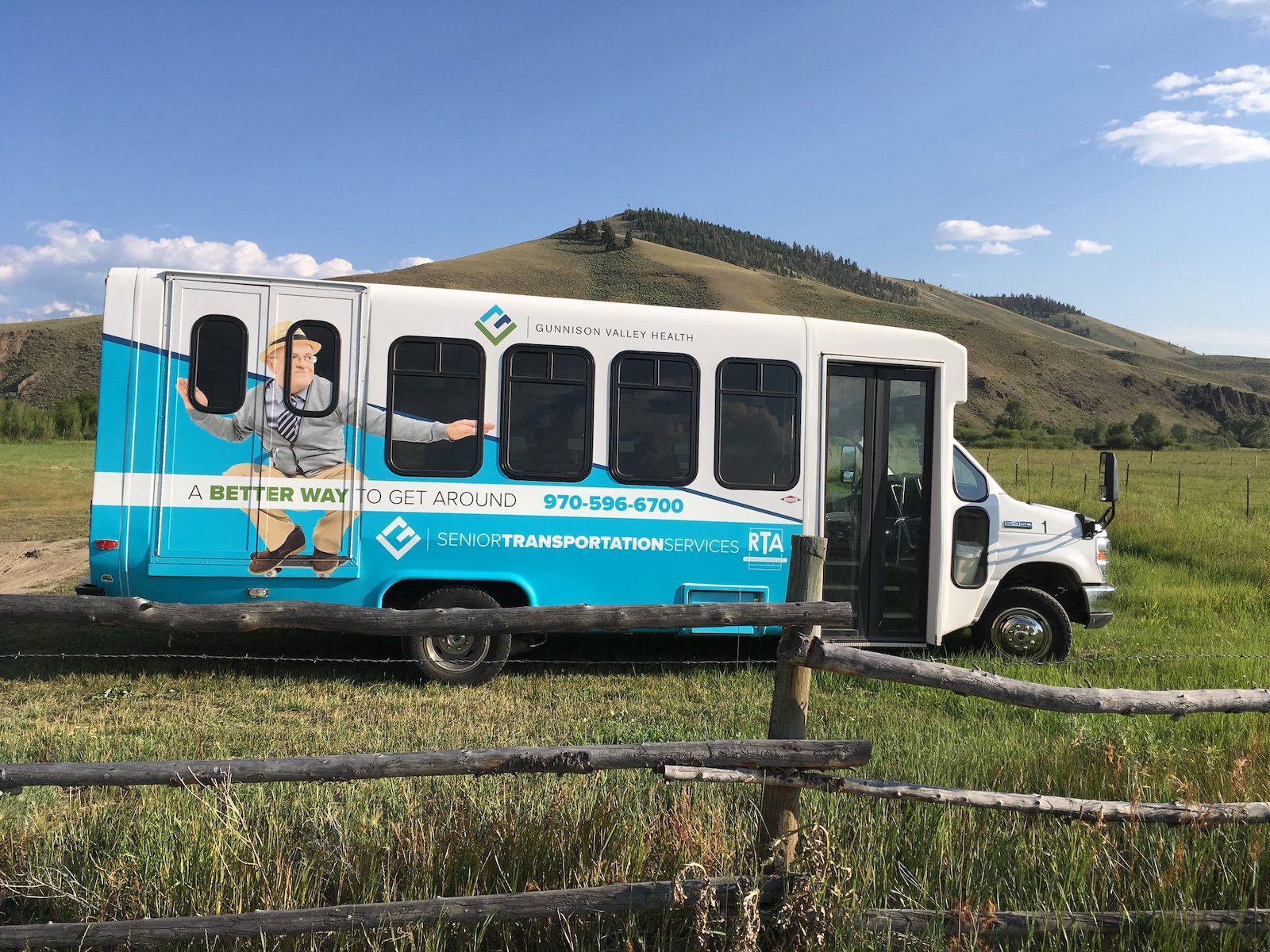 Gunnison Valley RTA shuttle bus parked in the grass