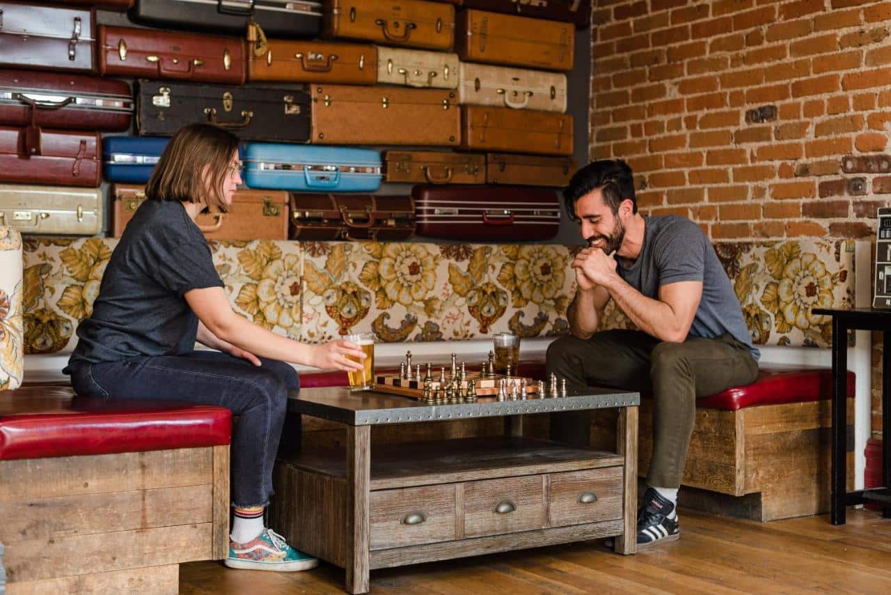 2 people play chess at Hostel Fish in Denver, CO