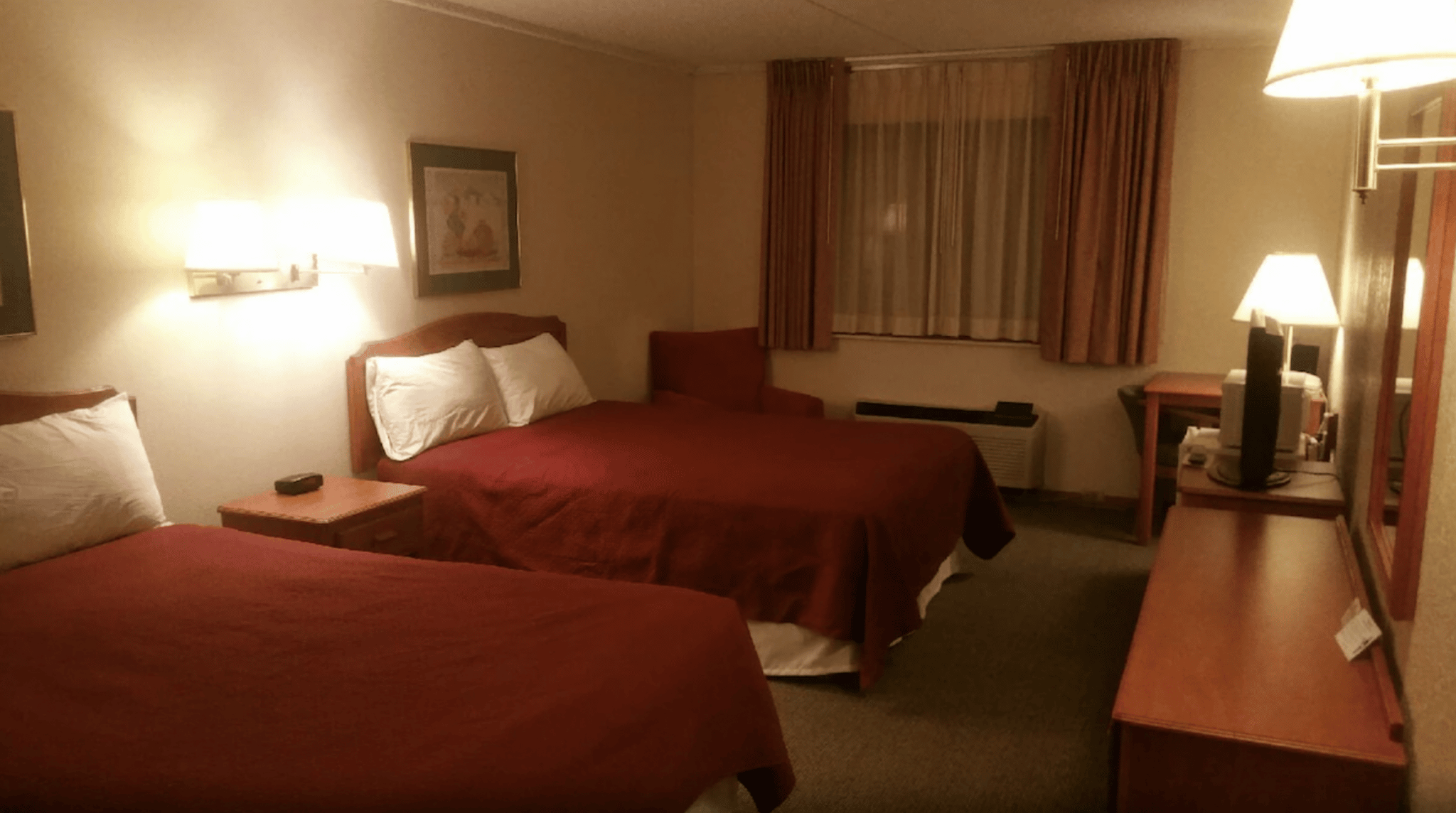 Hotel room in Las Animas with two double beds with red comforters