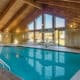 Indoor swimming pool with vaulted wooden ceiling at AmericInn by Wyndham Windsor Ft. Collins