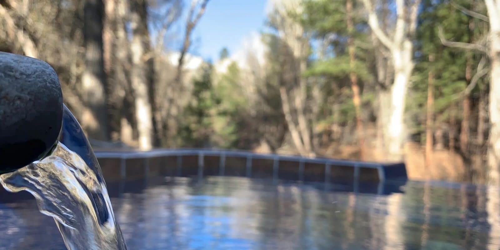 Water flowing from a pipe into Aqua Hot Spring Nathrop CO