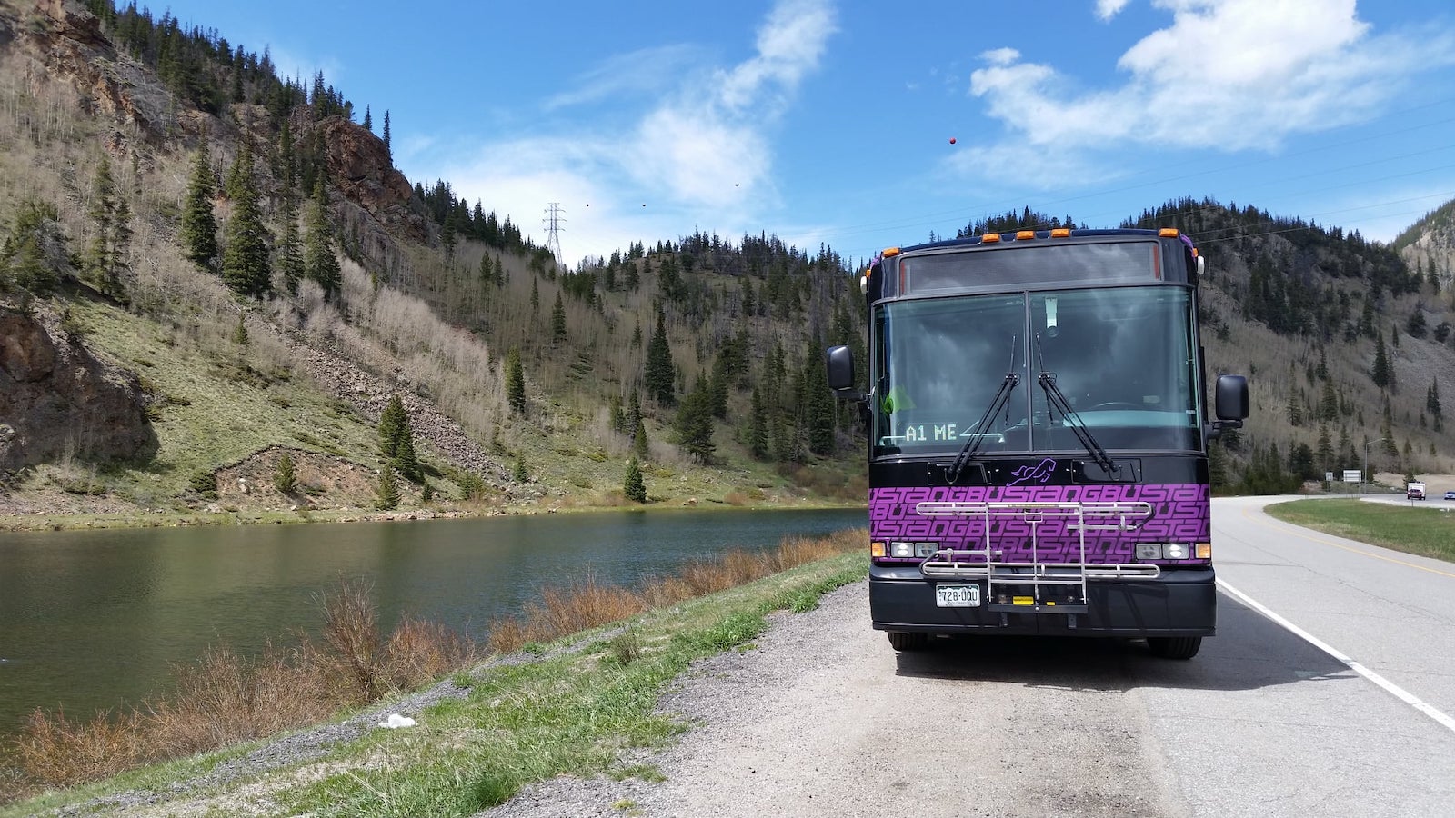 Bustang Bus in the Rocky Mountains beside a lake in Colorado