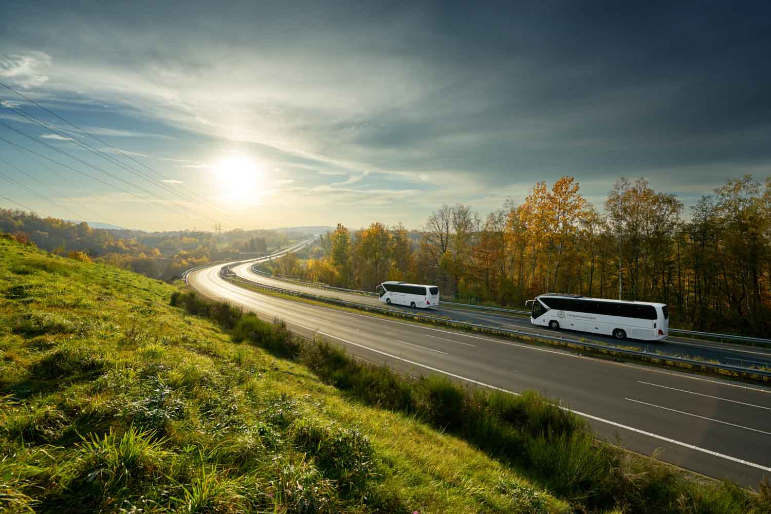 2 Colorado Coach Lines buses driving on a scenic highway