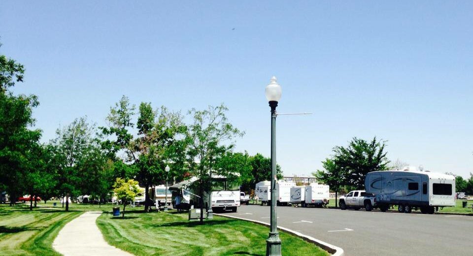 Street corner by a city park with RVs parked outside