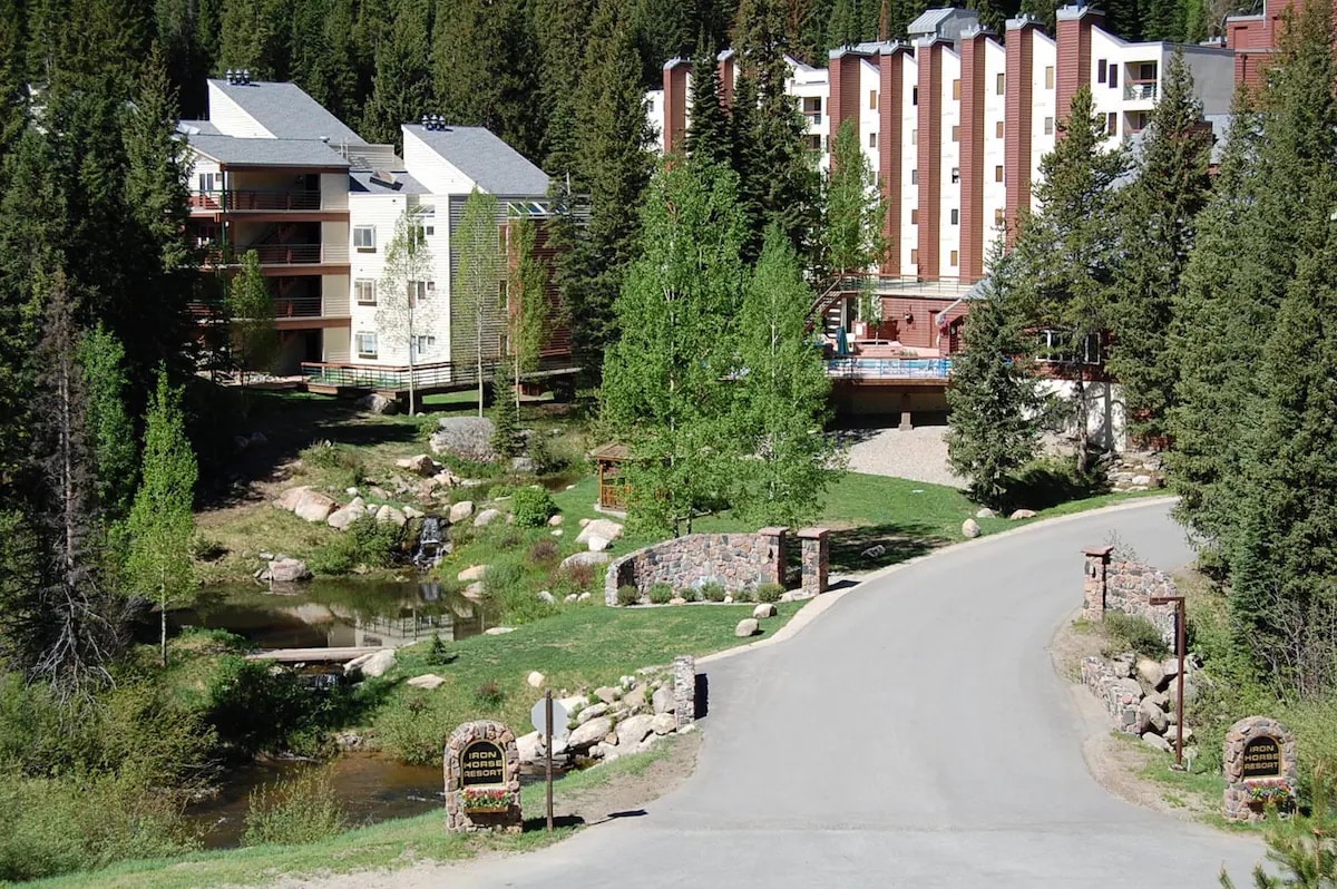 Exterior photo of Iron Horse Resort with swimming pool and small pond