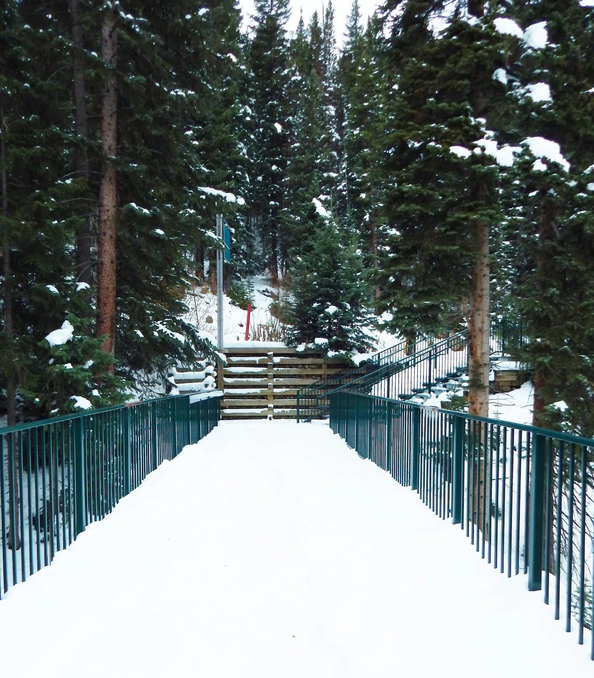 Iron Horse Resort snow covered path to The Corridor ski trail Winter Park