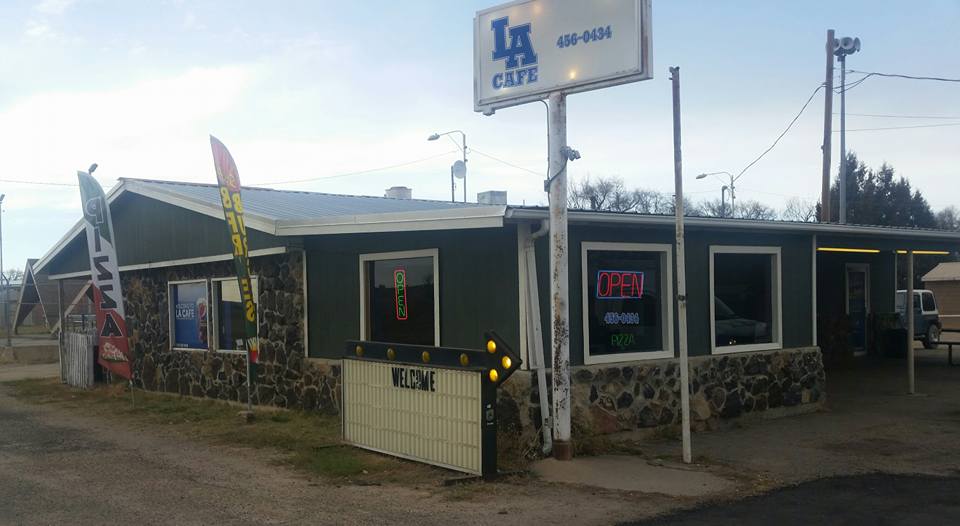 One-story restaurant building with a white LA Cafe sign in Las Animas