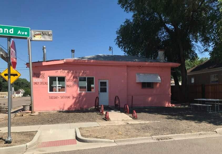 Bright pink, one-story building with Majestyk Cafe painted in black on the front