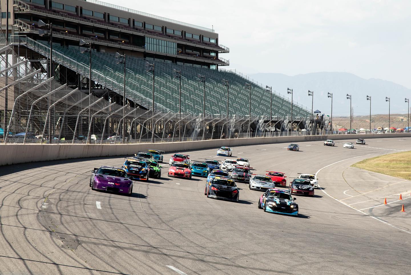 Cars racing on a large speedway