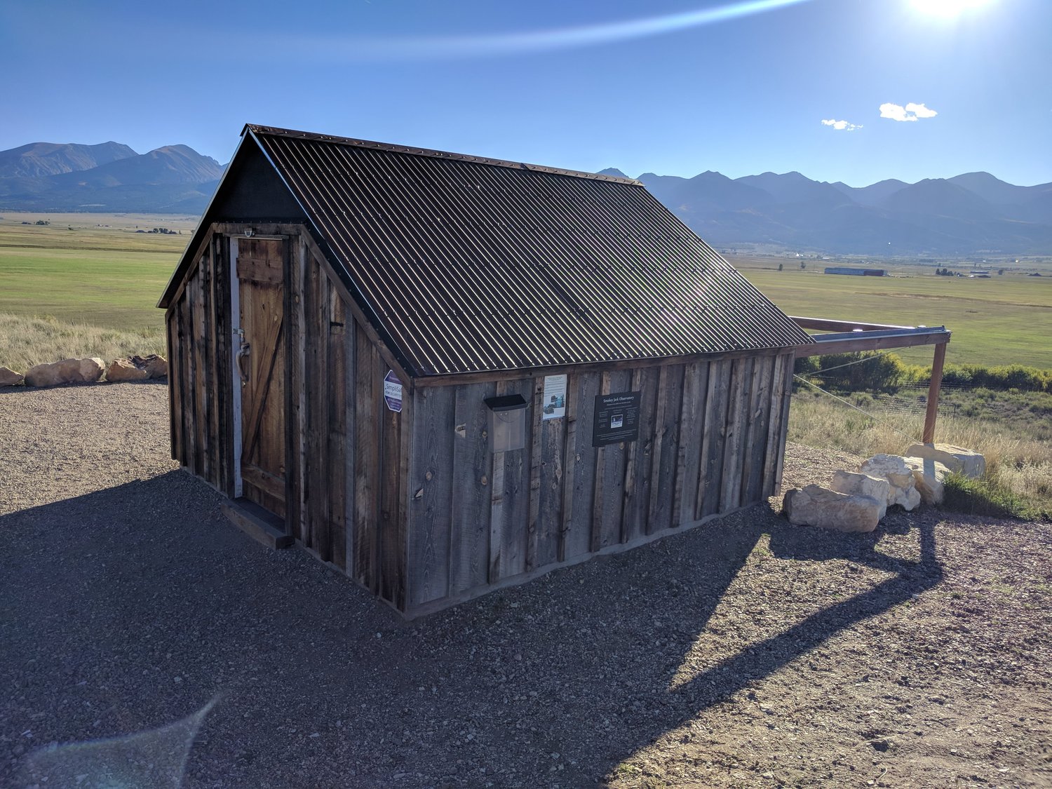 Small wooden building next to a field