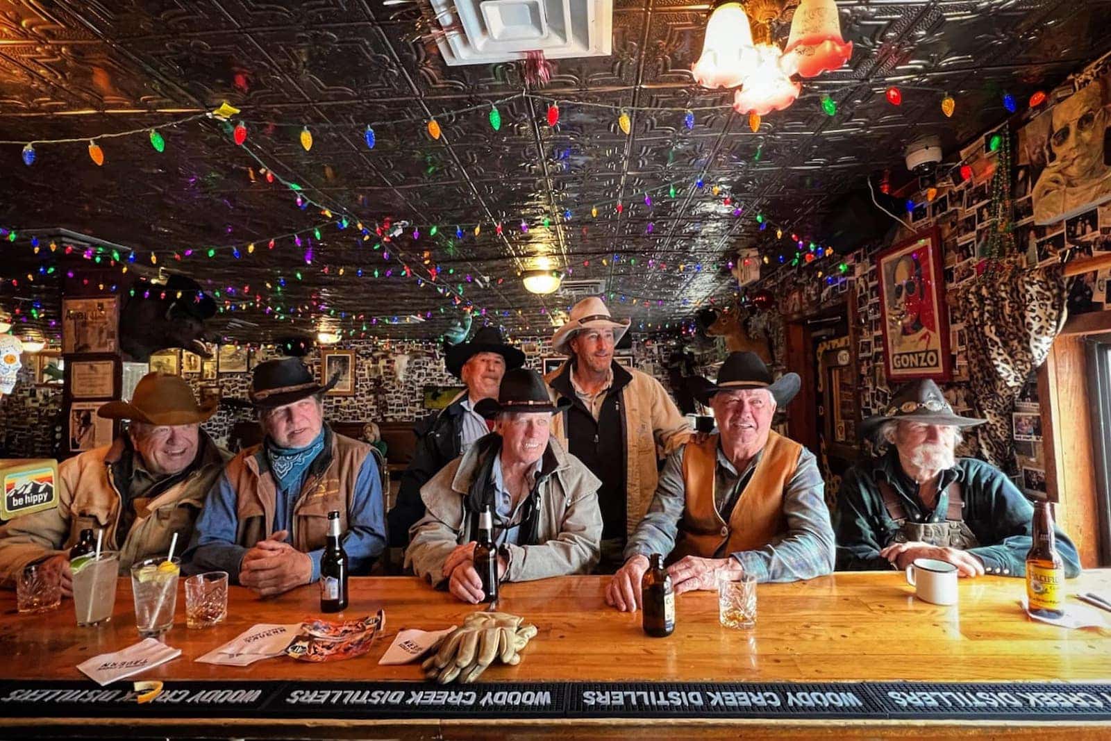 Cowboys sat at the bar at Woody Creek Tavern having beers