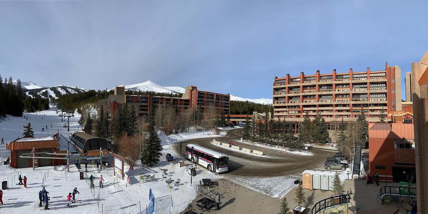 Front of Beaver Run Resort and Conference Center with a ski lift right next to the driveway