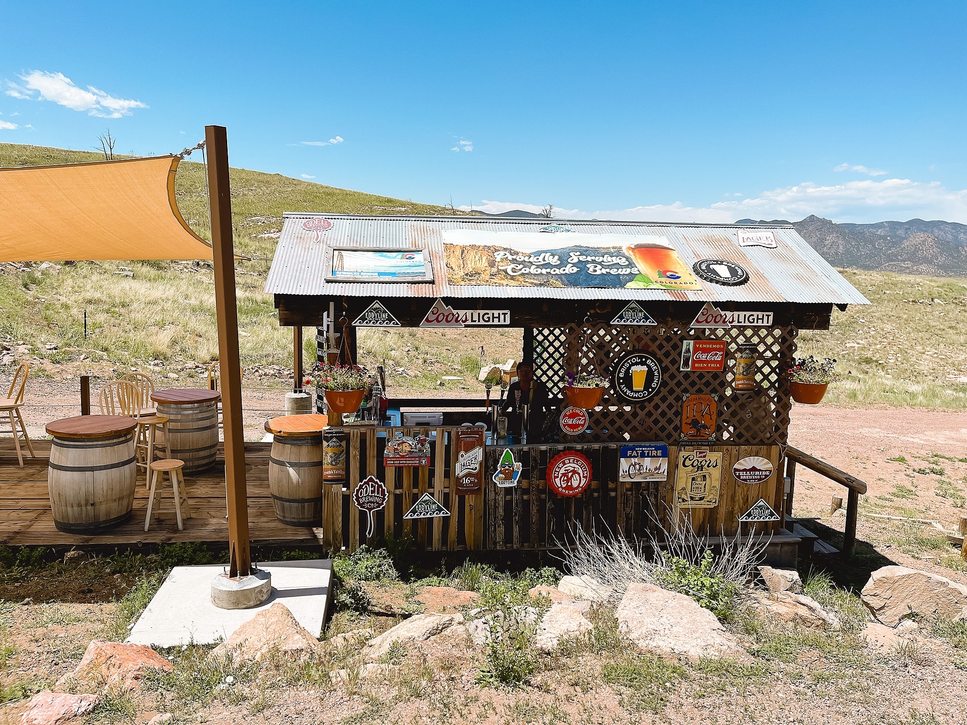 Wooden food stand hut with a lot of old, distressed metal beer signs at Royal Gorge Bridge and Park