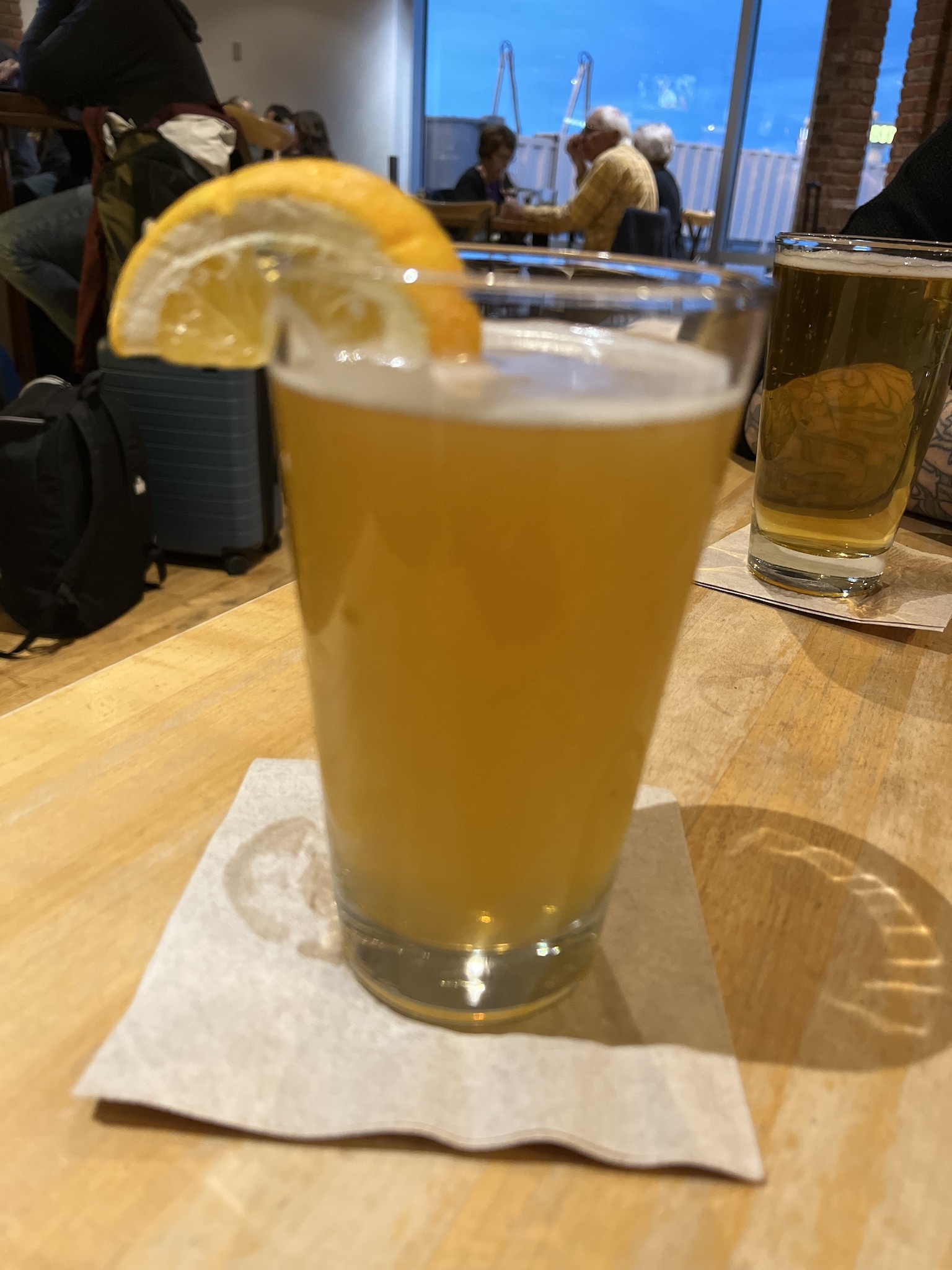 pint of wheat ridge with an orange slice served in the Denver Airport in Colorado