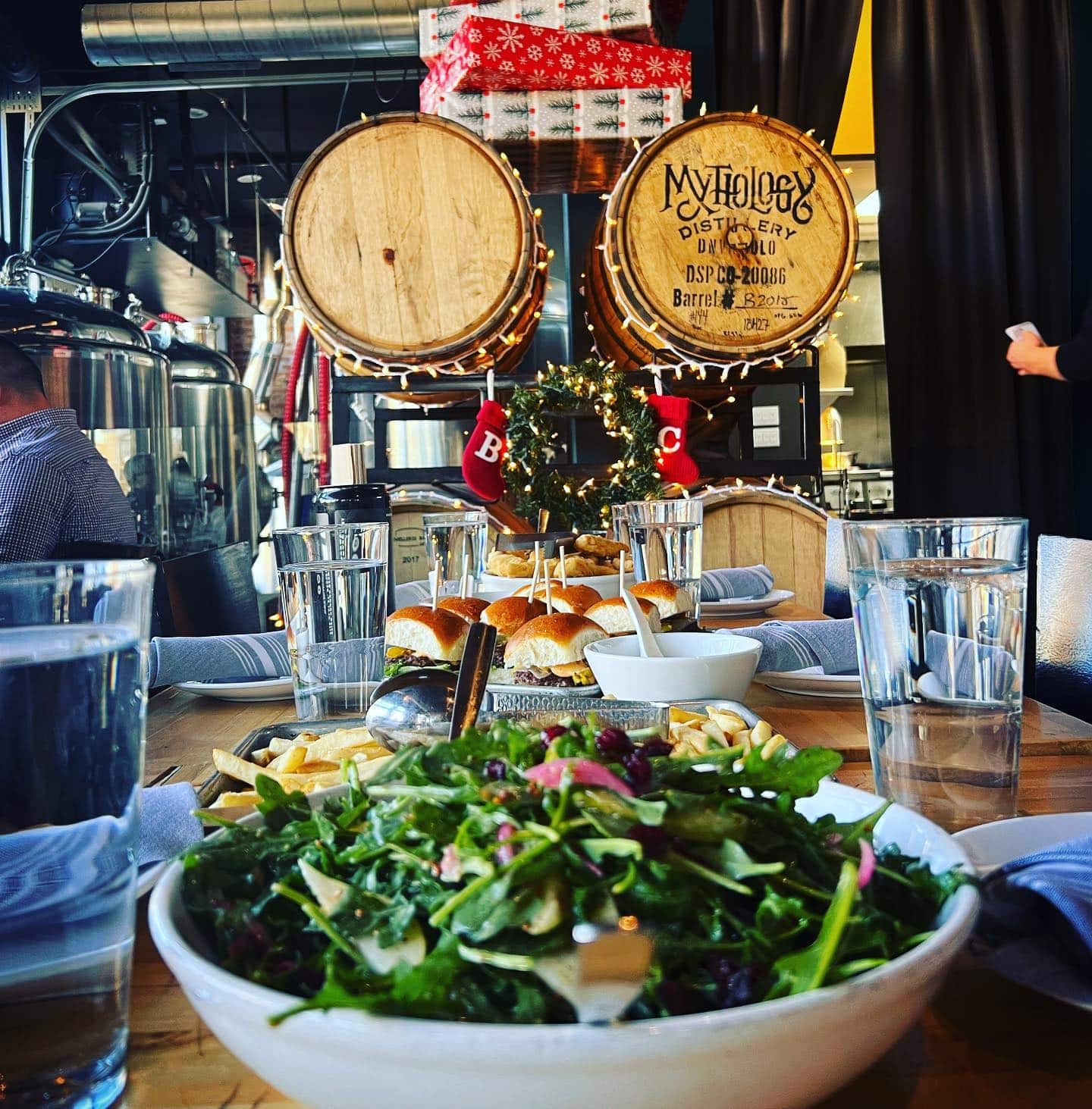 Salad and platter of burger sliders on a table at Briar Common Brewery + Eatery in Denver