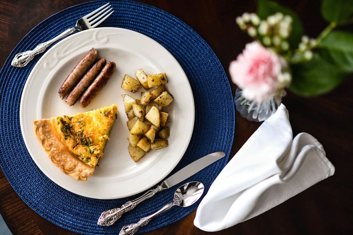 Breakfast plate with sauce, home fries and quiche from China Clipper Inn