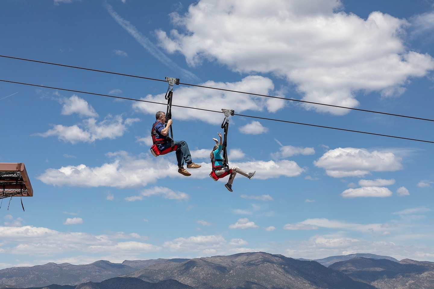 Two people in red harnesses on the Cloudscraper Zipline at Royal Gorge Park