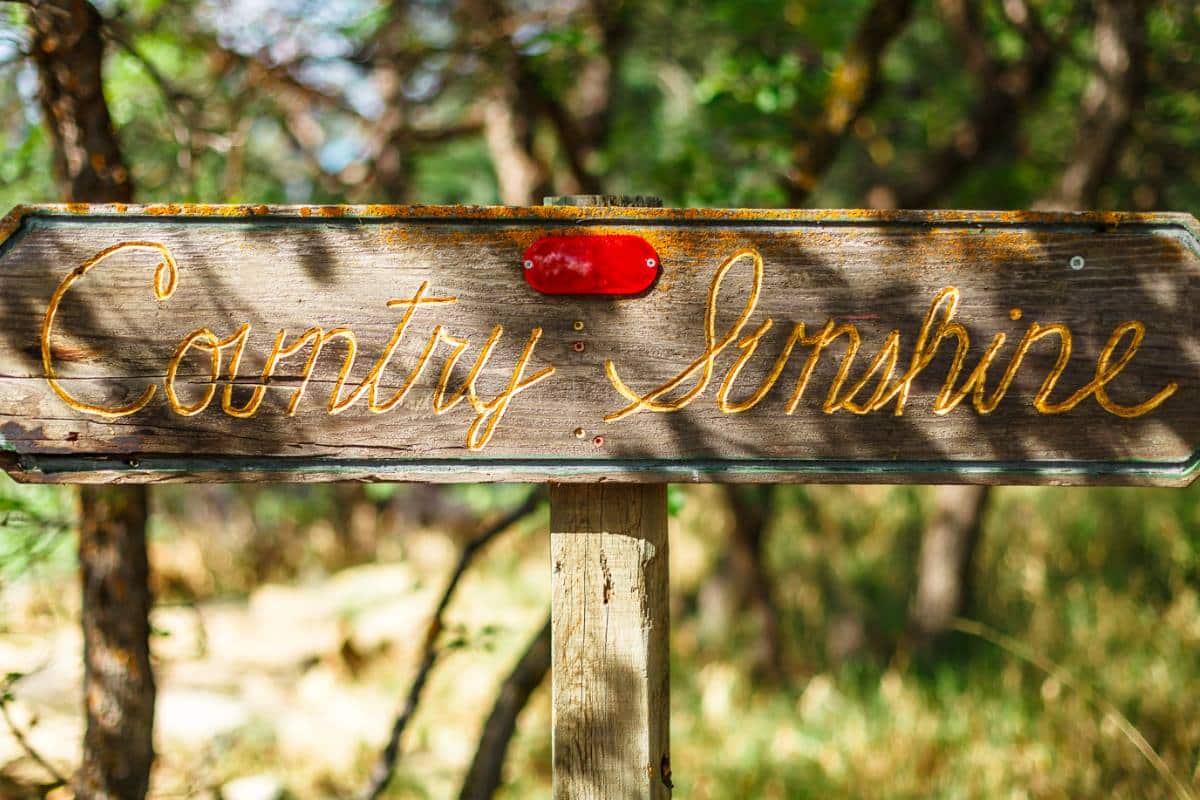 Wooden sign reading "Country Sunshine" outside the Country Sunshine Bed and Breakfast in Durango, Colorado