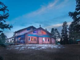 Evening exterior of the Elktrace Bed and Breakfast in Pagosa Springs, Colorado with some light snow on the ground