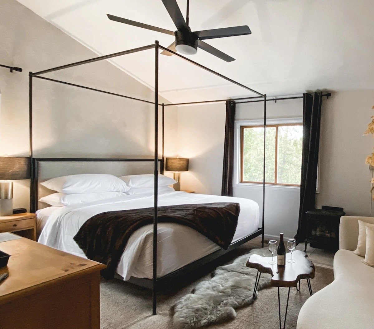 A fan hangs over the bed in the Aspen Room at the Juniper Mountain House