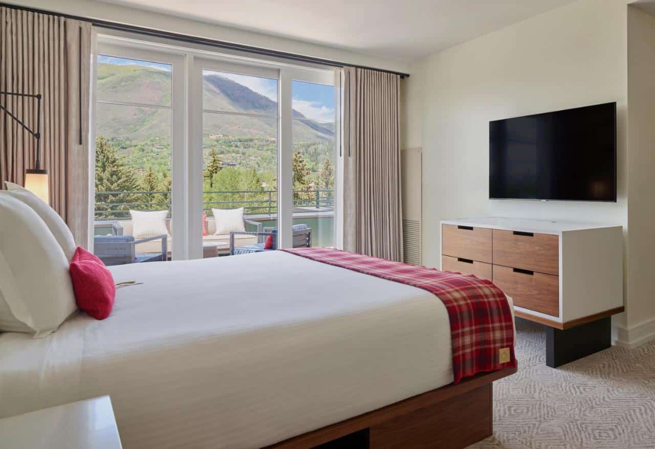 Hotel room showing bed and window looking out tot he mountains at Limelight Hotel Aspen