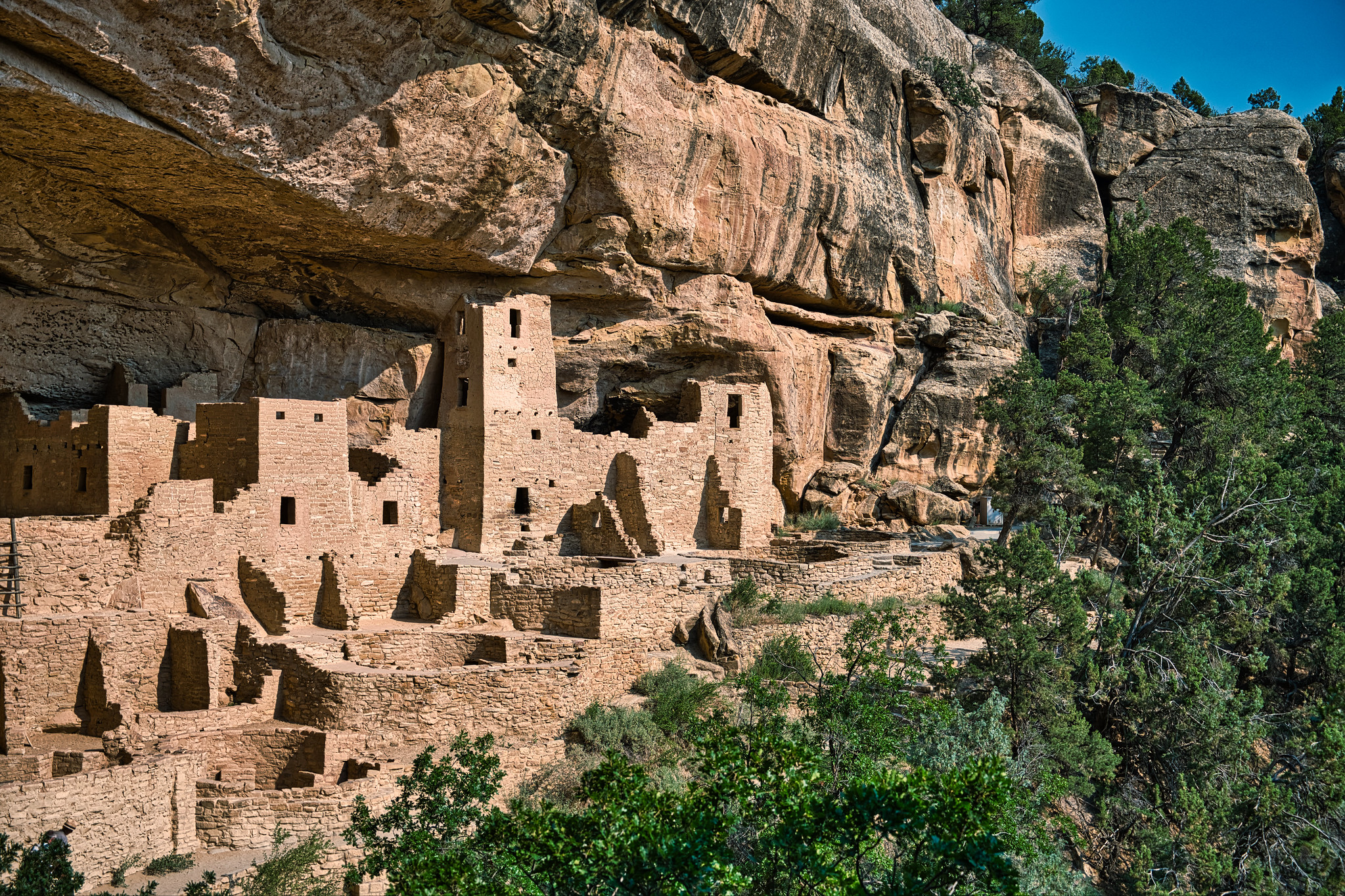 Ancient cave dwelling in the side of a red rock cliff at Mesa Verde National Park