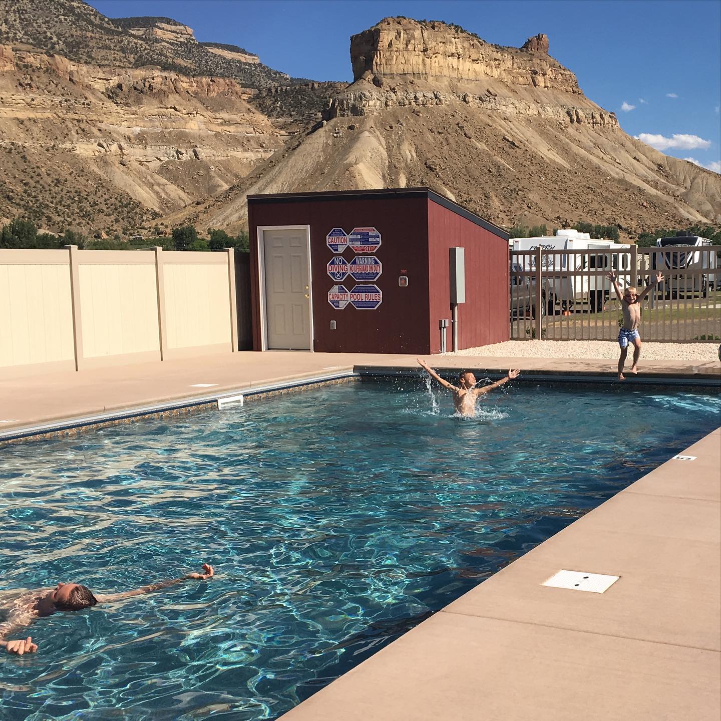 Kids play in the swimming pool at Palisade Basecamp RV Resort in Colorado