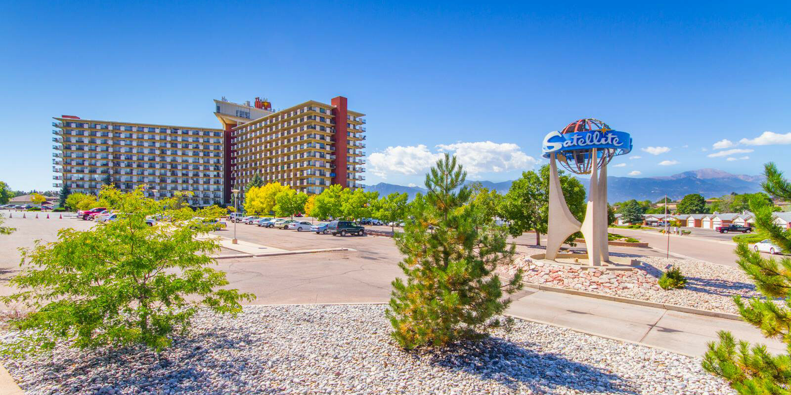 Hotel building on the left side and Satellite Hotel sign on the right