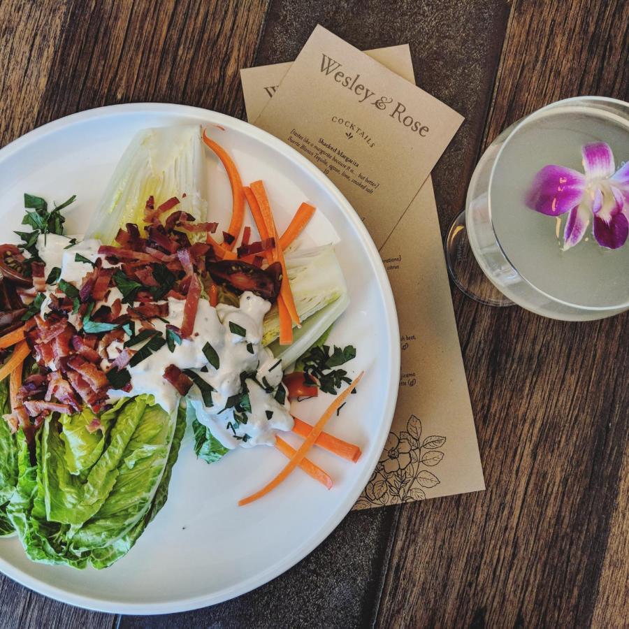 a white plate with a salad from Wesley & Rose inside the Surf Hotel Buena Vista Colorado