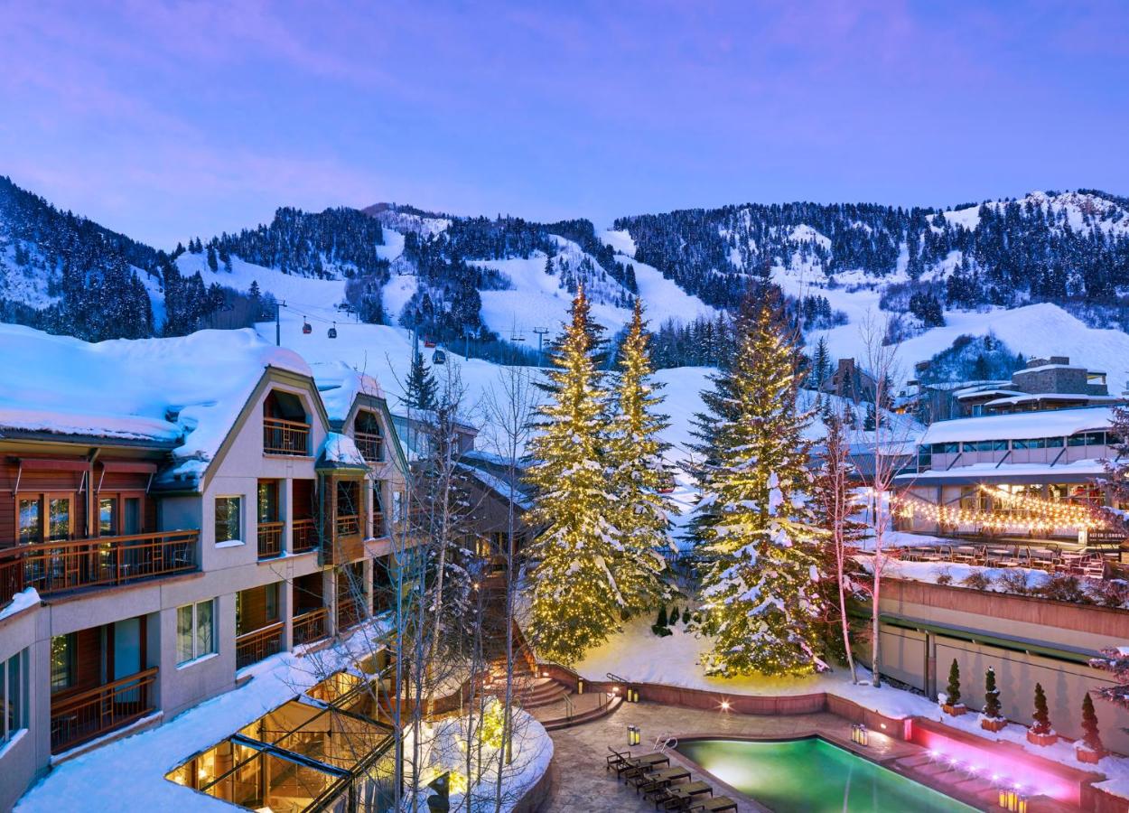 Overlooking the outdoor swimming pool with a view of Aspen Mountain in wintertime at The Little Nell