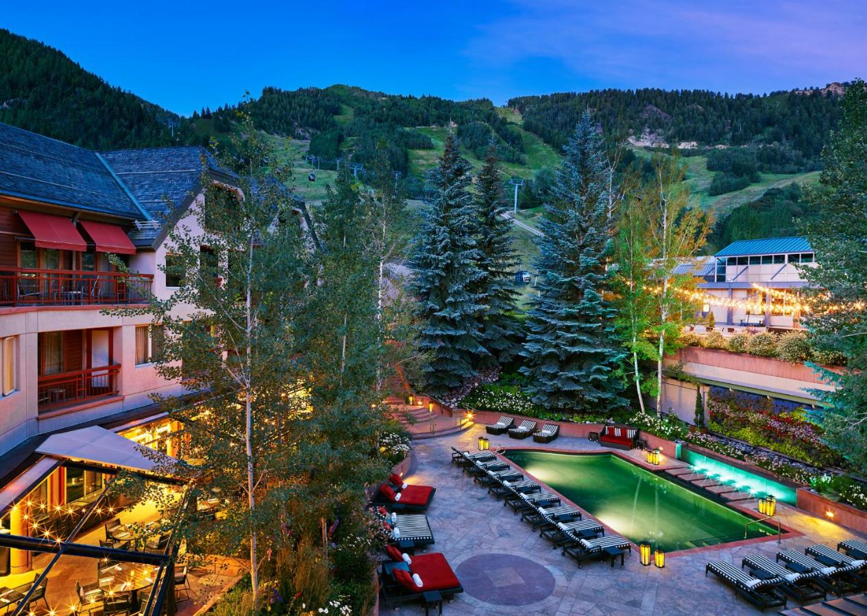 Overlooking the outdoor swimming pool with a view of Aspen Mountain in late summer at The Little Nell