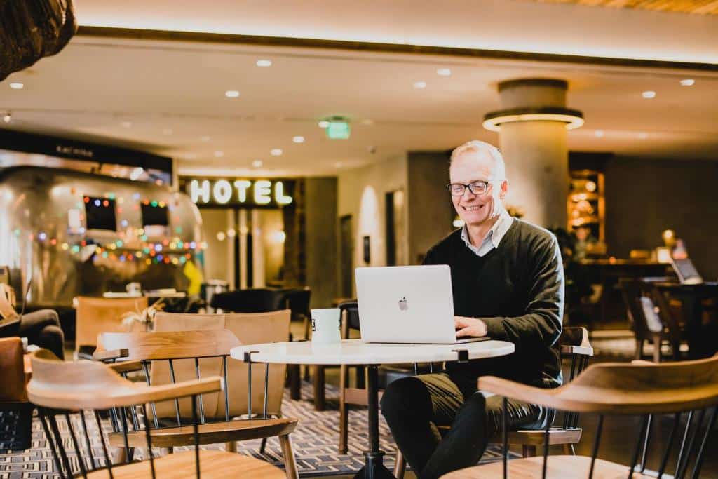 Man working in the. lobby of The Maven Hotel at Dairy Block in Denver, Colorado