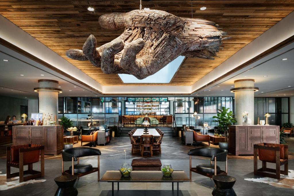 Giant hand art sculpture hangin from the ceiling at The Maven Hotel at Dairy Block in Denver, Colorado