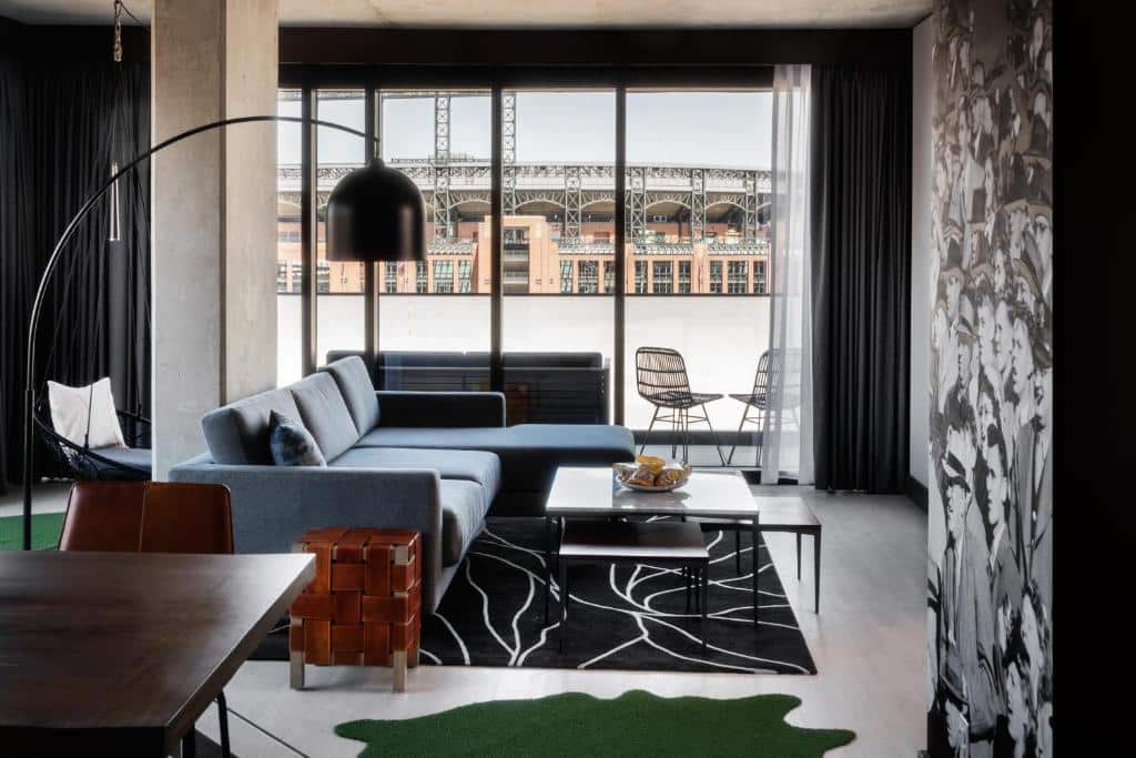 Hotel living room with view of the baseball stadium at The Maven Hotel at Dairy Block in Denver, Colorado