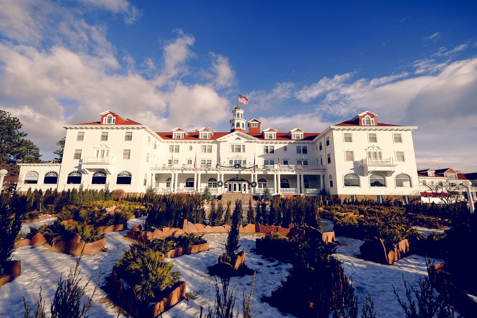 Winter snow surrounds the front exterior of the Stanley Hotel in Estes Park, Colorado