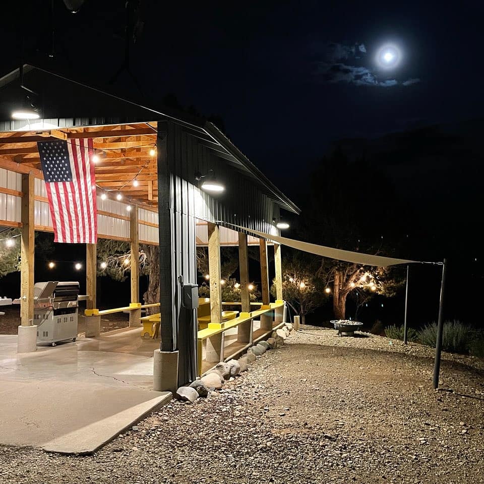 The barbecue grill and covered picnic table at The Views RV Park at nighttime in Dolores, Colorado