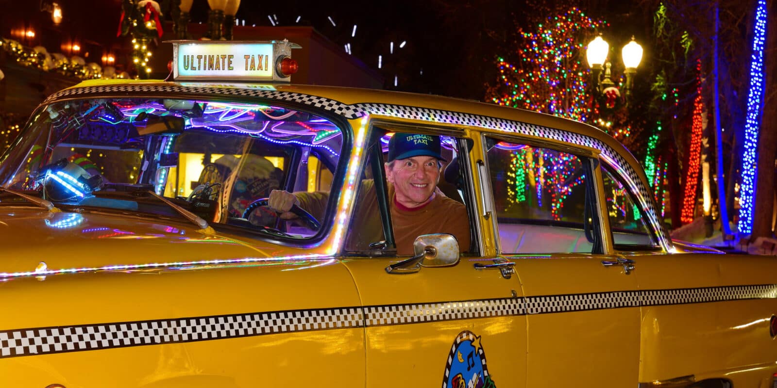 Yellow taxi cab with happy driver at the Ultimate Taxi in Aspen