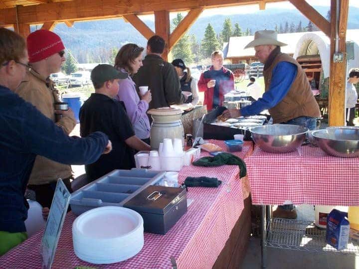 People lining up for pancakes hot of the griddle at Winding River Resort in Grand Lake, Colorado