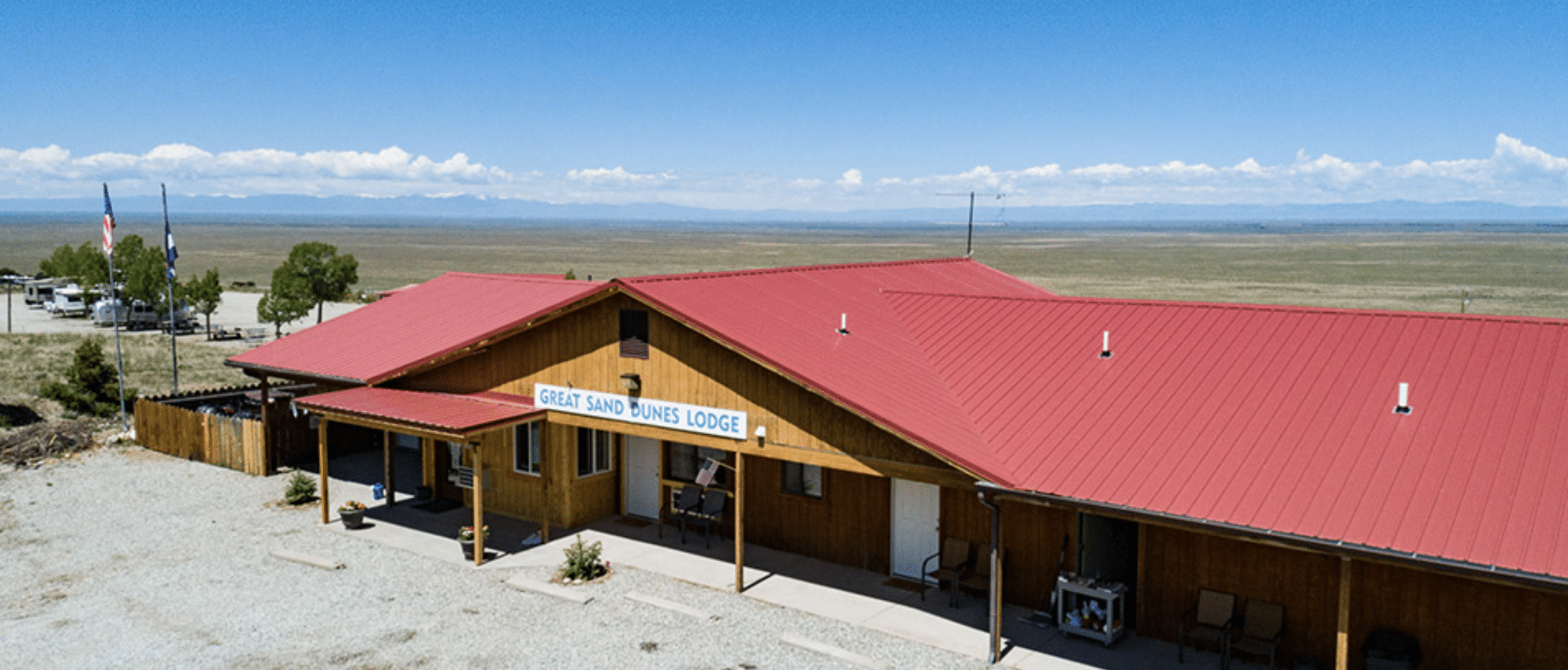 Single-story red roofed Great Sand Dunes Lodge