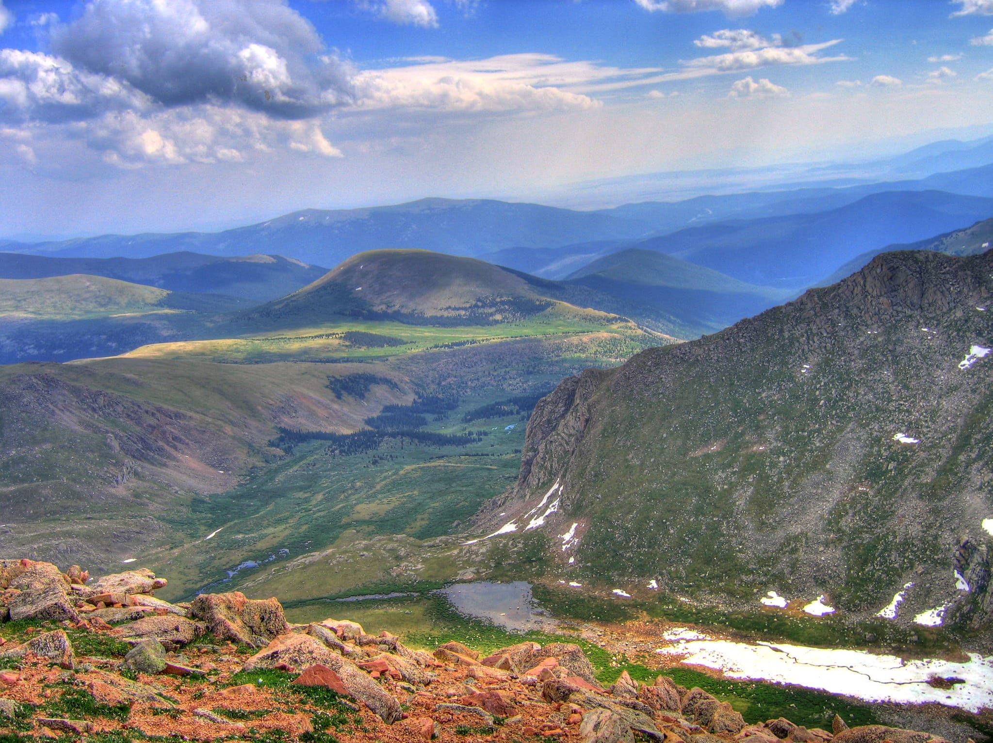Views from near the top of the Mount Blue Sky Scenic Byway. Pictured is a sweeping view of rolling green mountains