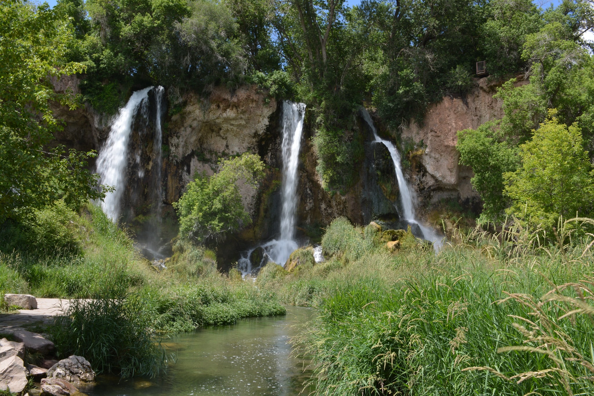 Three waterfalls surrounded by lush greenery at Rifle Falls State Park