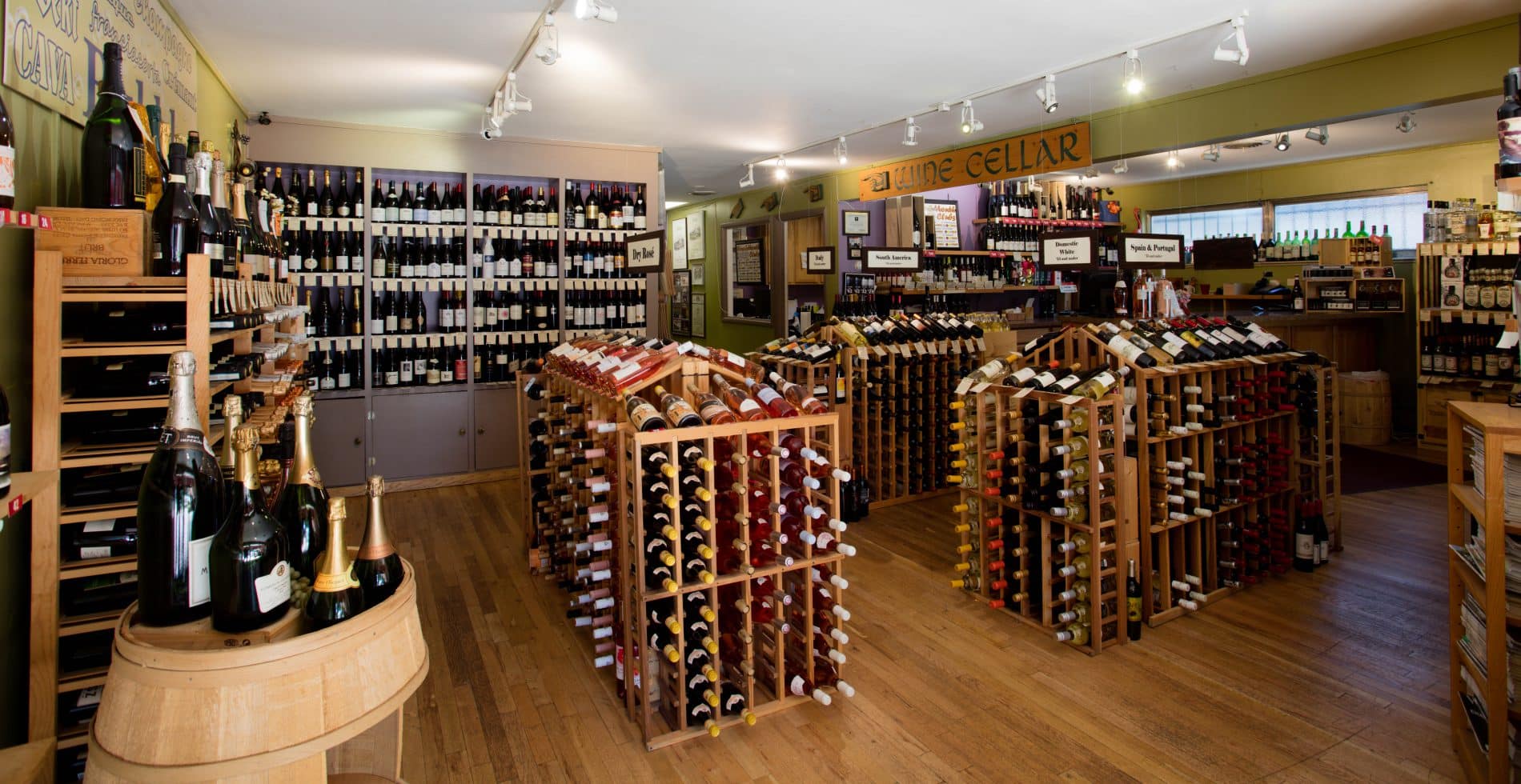 Inside of The Vineyard Wine Shop in Denver. Large room filled with racks of wine