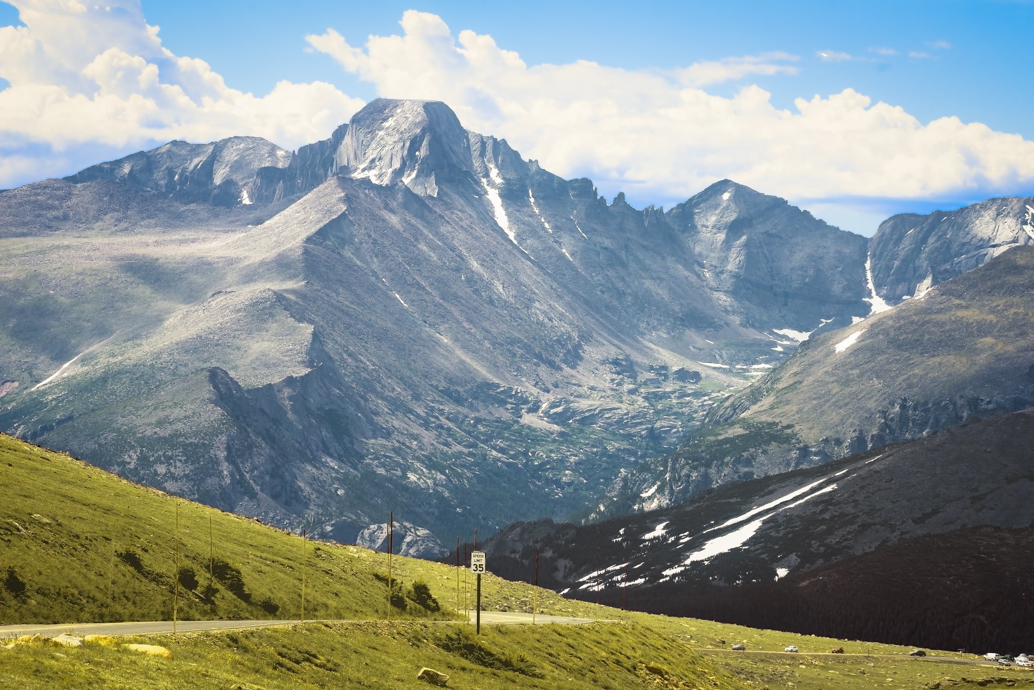 Huge mountains at Rocky Mountain National Park in the background and winding Trail Ridge Road Scenic Byway in the foreground