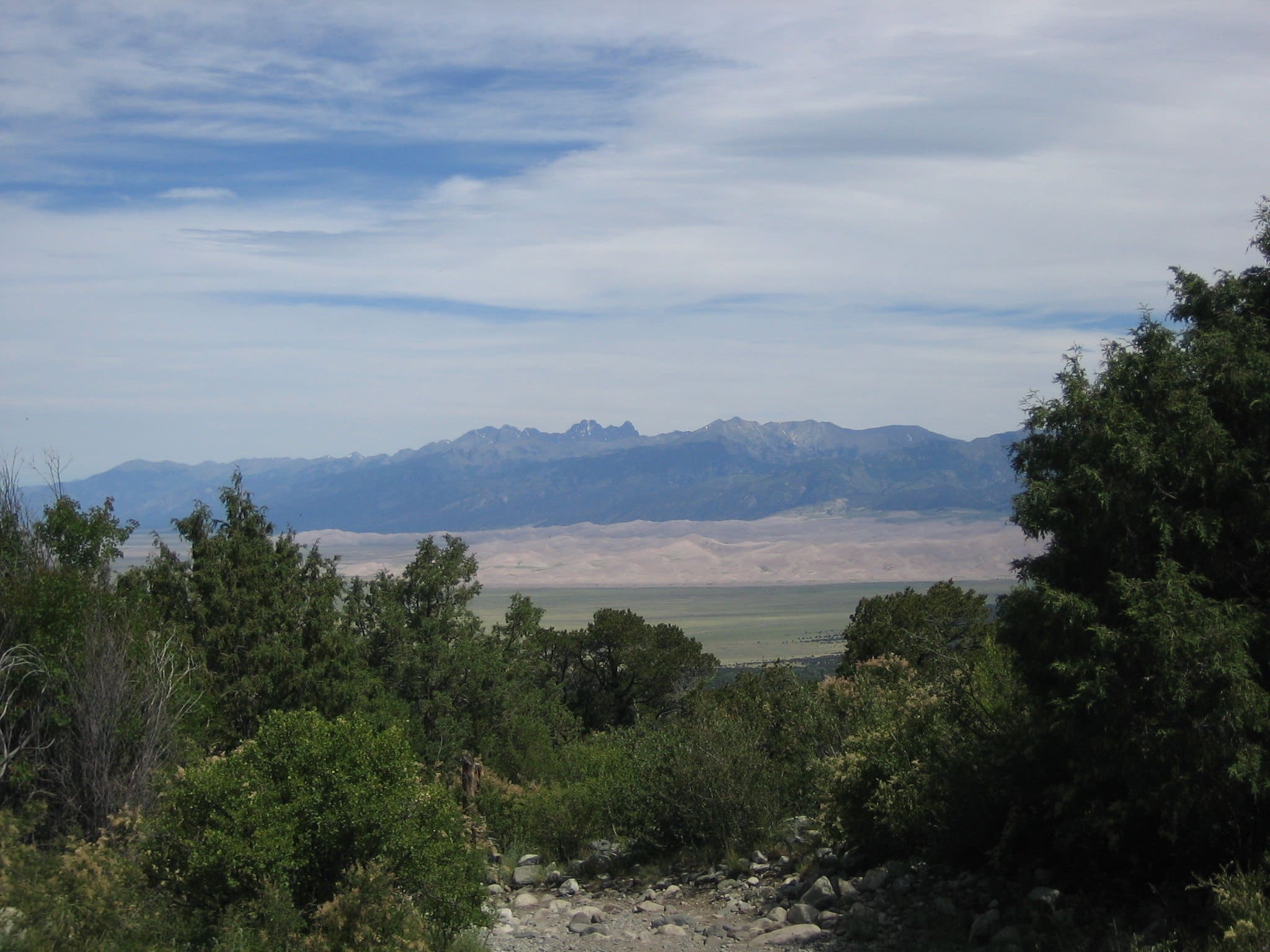 View of Great Sand Dunes National Park sand dunes with mountains in the back from the hiking trail to Zapata Falls