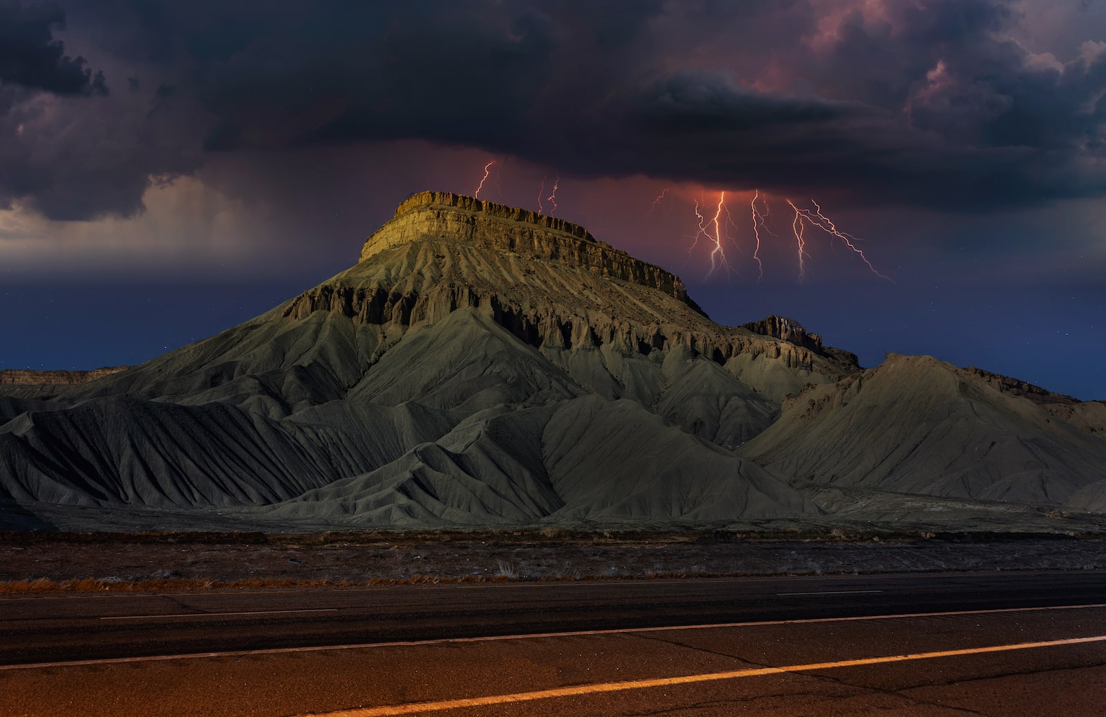 Lightning flashes over Mount Garfield in Mesa County, Colorado