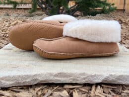 Sundance Sheepskin & Leather moccasins on a rock