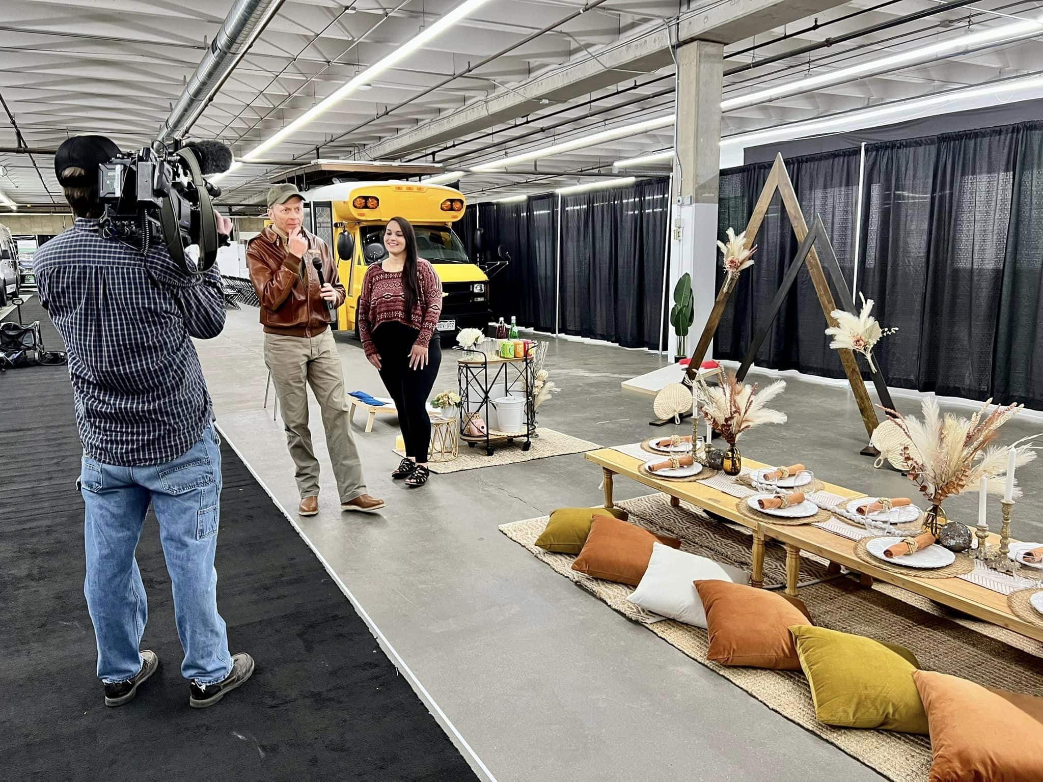 A reporter interviews a woman at the Denver Home Show