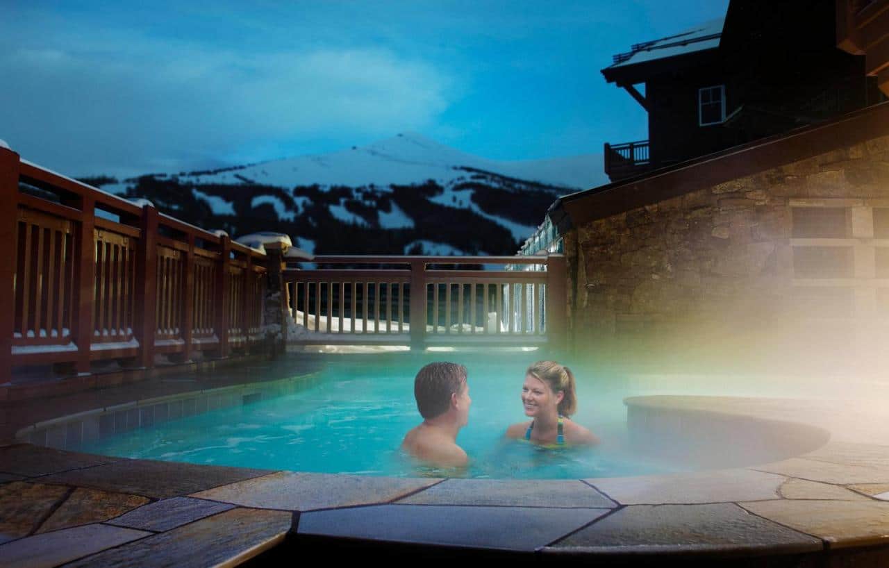 Couple in outdoor swimming pool at One Ski Hill in Breckenridge, Colorado